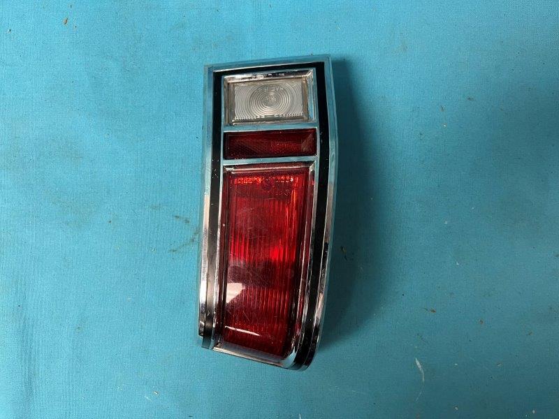 Taillight Assembly - Drivers side.  the red lens does have a crack in it.  New reproduction red taillight lenses are available from Layson's Restorations Inc.