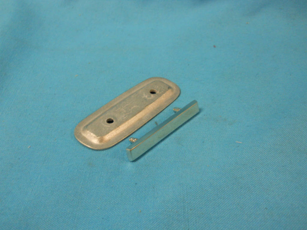 Deluxe Seat Chrome Insert with back attachment plate (each).Reproductions.  This was Chryslers original part #2887 163.  1 per seat are needed (4 per car).  These are located at the center of the upper backrest portion of the seat on the front buckets as well as the rear bench.