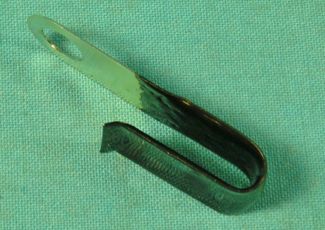 Wire retaining clip - – 727 Tranny - located under either of the upper Tail shaft mounting bolts for automatic transmission Applications. Once in place, the clip is bent forward to rest on the transmission case.