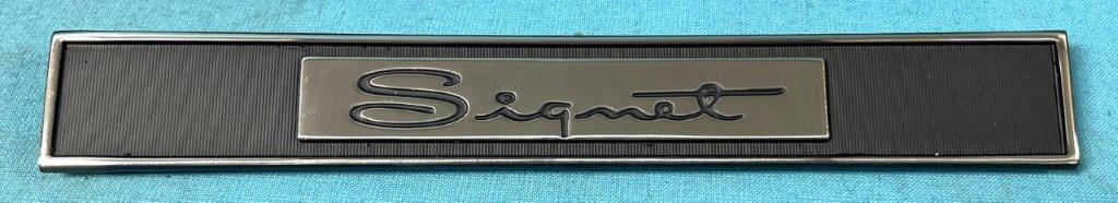 Inner Door Panel emblem - "Signet".. Retangular piece just below vent window.