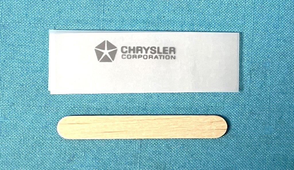 Light Grey Chrysler Corporation Stamping - Factory Exact VIN Plate Dry Chrysler Transfer.  This latex ink dry transfer is a perfect reproduction of the original used by Chrysler.  They are basically a "portable" stamping and do not require baking or other difficult application process.  Transfer time is about 20 minutes.  Instructions included.