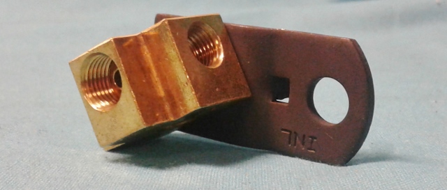 Distribution block - mounted below the master cylinder which feeds fluid to all four wheels.  Factory drum brake cars.  Brass with phosphate Bracket.