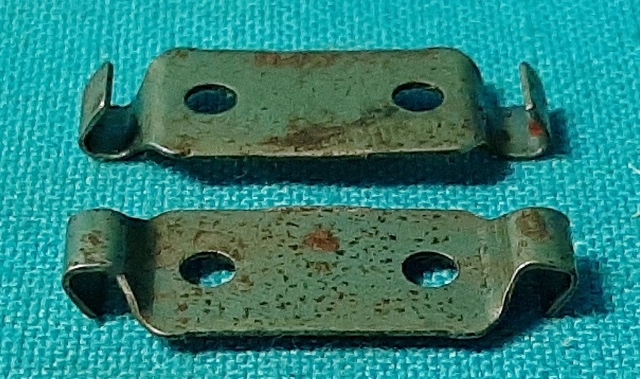 Inner Door panel emblem retaining clip.  Found on the backside of the upper door panel emblems found on all A-body vehicles for these years.  This emblem is flat and rectangular and usually has a script of "Barracuda", "Valiant", "Signet-200", "Dart GT", etc...this clip is mounted to the backside of these emblems where the emblem goes into the two large holes found on the upper door panel painted surface.