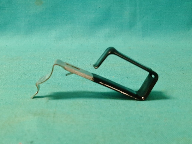 Firewall Wiring Clip - an excellent reproduction of the SHORT version wiring clip located on the brake pedal reinforcement bracket.  Used on both power and standard brake applications.  Formed form correct gauge galvanized material and thermo-plastic coated for original appearance.