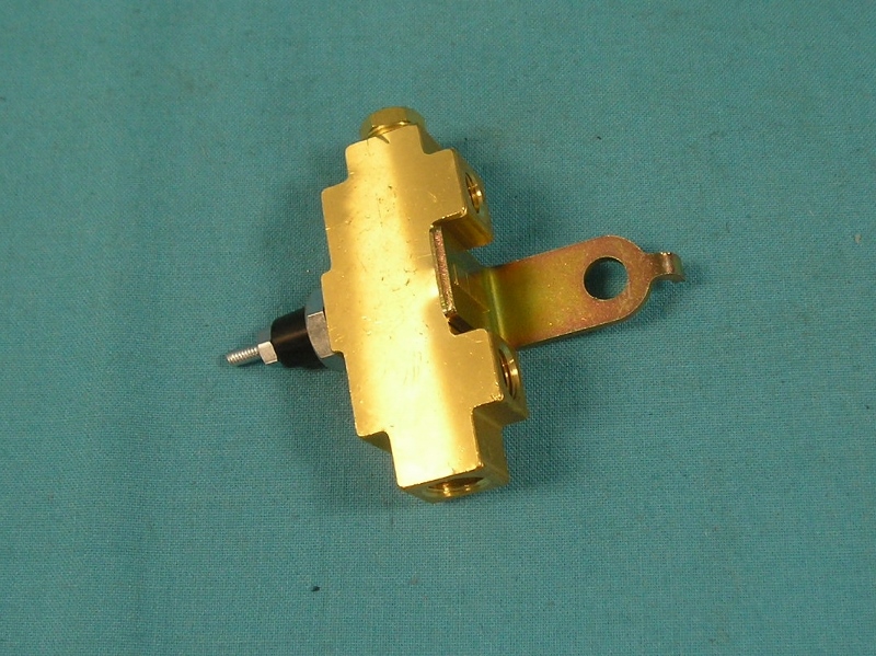 Proportioning Valve - Brass 5 Port Valve for Disc. or Drum brakes. 
If your Mopar had drum brakes you had the valve to the right and maybe the texas shaped rear hold off valve. The third valve was used in junction with the distribution block and the hold off texas valve on factory disc brake cars. So the valve on the long silver bracket was only on only disc brake cars. Some Mopar's had the texas shaped valve and the distribution combine into one valve so your car may only have one valve for drum brakes and two valves for disc brakes, see BLK246 for more info.

This is the distribution block that is mounted below the master cylinder which feeds fluid to all four wheels.