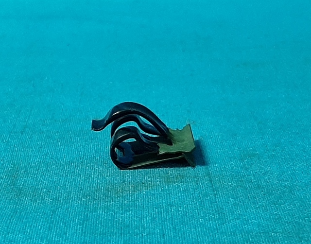 Wire loom metal clip on cowl seam (rubber covered)