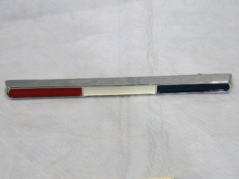 Grill ornament. Rectangular tri-colored emblem that mounts in the front center of the grill