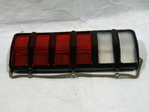 Drivers Side Tail light Lens. Notify at time of order if flat black or gloss black version on lens.  Flat black was for vehicles with the flat black tailpanel stripe - Discount exempt