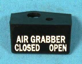 Air Grabber Switch Bezel - Black Plastic with white letters “Air Grabber” - This is the black plastic bezel that says "AIR GRABBER CLOSED - OPEN" mounted under the dash to the right of the steering column and only on the cars with the fresh air hood option ie) air grabber hoods

This black plastic switch bezel has white letters.