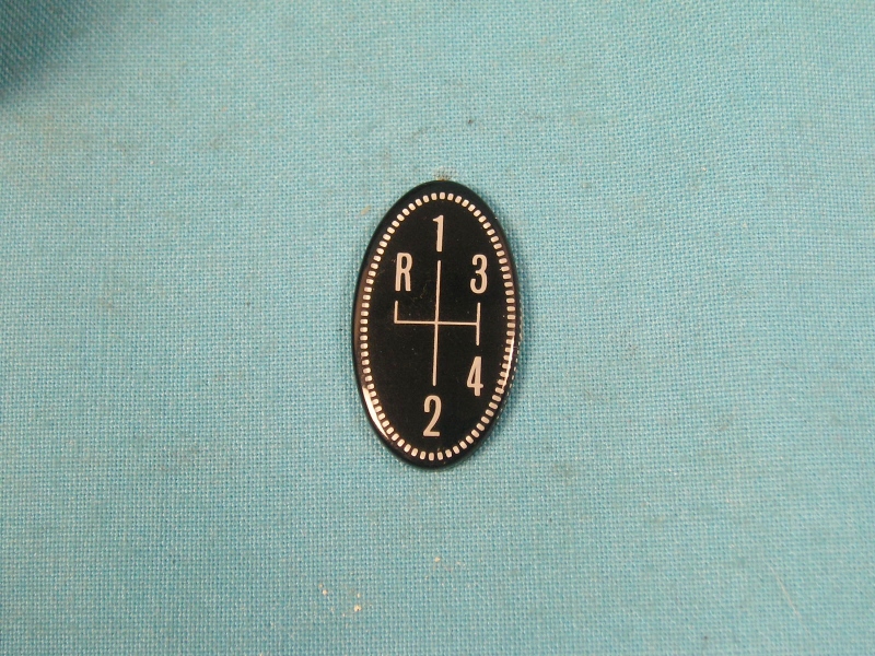 Oval pistol shift lens - 4-speed pattern in white on black background.  Pistol grip top lens.  Excellent reproduction of the oval lens at the top of the shifter handle. 
Better than our competitions product, ours have clean edges and uniform dots around the edge.  Ours 
has the correct number size and they are not off center...just a better reproduction
