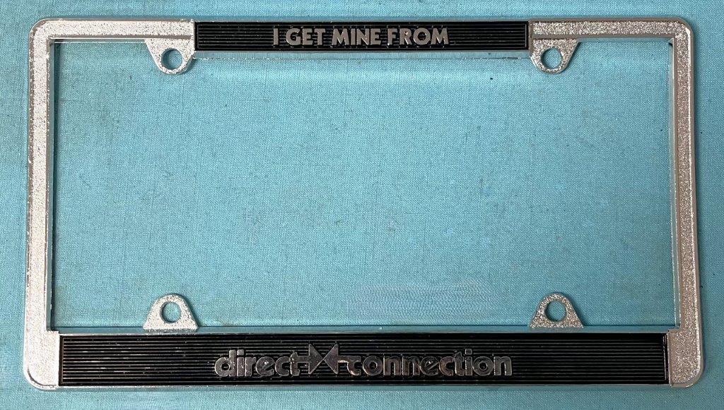 Discontinued - License Plate Frame - TOP reads - "I GET MINE FROM"..Bottom reads - "DIRECT CONNECTION"...all metal frame as appeared on many cars in 1960's
