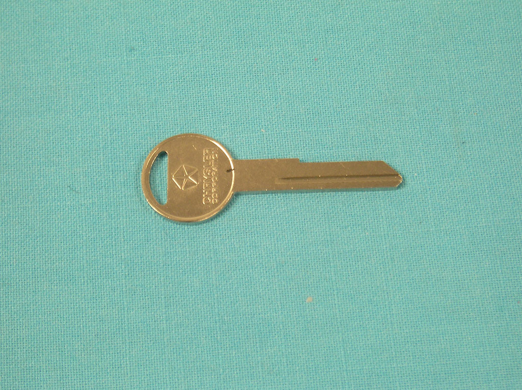 Glovebox and trunklid key blank. Key has a Pentastar and the words "Chrysler Corporation" stamped on both sides.