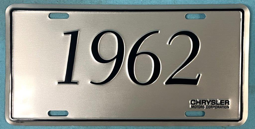 Plate Silver plate, shows the year (1962) of the car in black script.