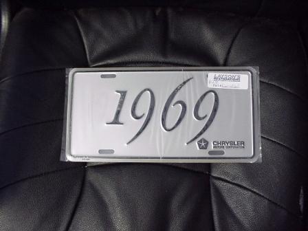 License Plate Silver plate, shows the year (1969) of the car in black script.