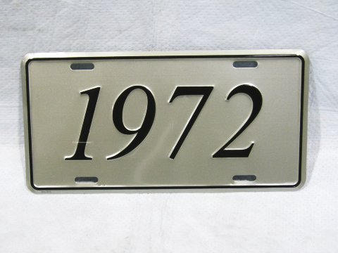 License Plate Silver plate, shows the year (1972) of the car in black script.