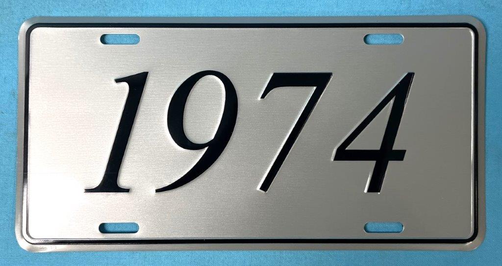 License Plate Silver plate, shows the year (1974) of the car in black script.
