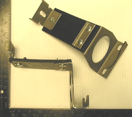 Resonator / Muffler To Floorpan Mounting Brackets (pair), Has an upper piece with four studs that attach to the inside of the floorpan behind the rear seat.  They also have a lower piece that attaches to the underside of the floorpan, then bolts to the upper bracket with the four protruding studs.  These reproductions are finished with the proper cadmium plating for correct appearance.  Use with our resonator hangers <b>(Part #AL-ERP)</b>