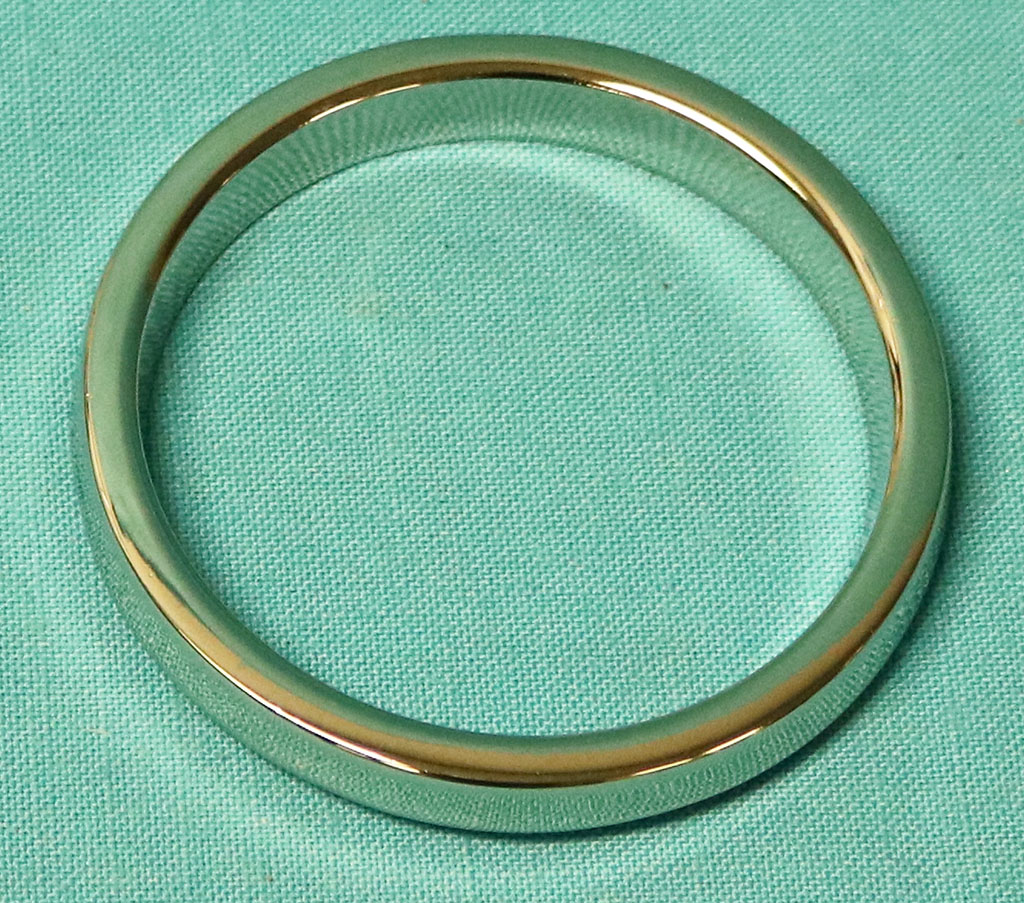 Taillight lens Inner round mldg on lens.  This lens molding is made of chromed metal - unlike originals that were plastic chromed.  These will need a JB weld to "glue" the metal to the inner ring of the lens.
