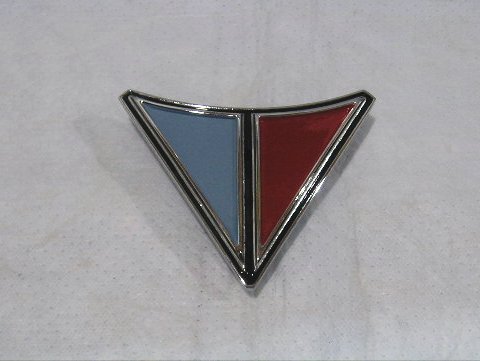 Trunk "V" emblem.  For 1965 this is for Valiant 100 and Valiant 200 series only - NOT the Signet-200 models.  For 1966 this is for ALL Valiants - including the Signet model.  Original part # 2526 268.

Not a Perfect Quality cosmetic Reproduction - some blems visible on reproduction based from tooling made from the best emblem we could find - very MINOR but can be seen if looking closely for it.