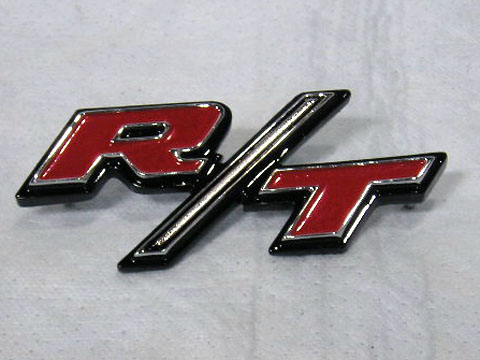 "R/T" tail panel emblem. The studs must be wedged into the holes as originals.