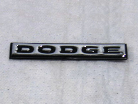 "DODGE" trunk lid emblem for 72-74 Chargers. Brushed finish with black lettering, adhesive backed.