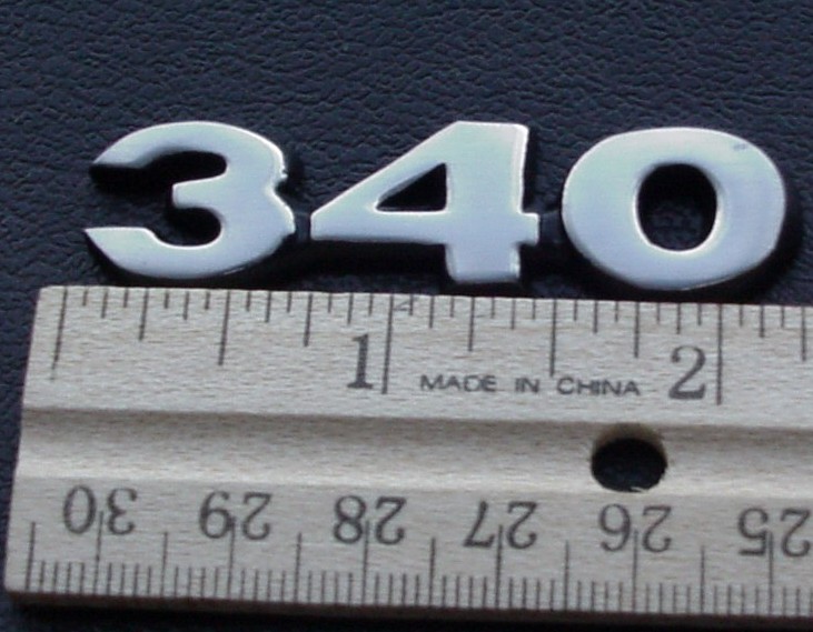 "340" fender nameplate with posts [70 Dart Swinger, 71-72 Dart & Demon, 73 Dart Sport].  1970 Dart / 1971-72 Demon - 340 is used on the hood scoops.