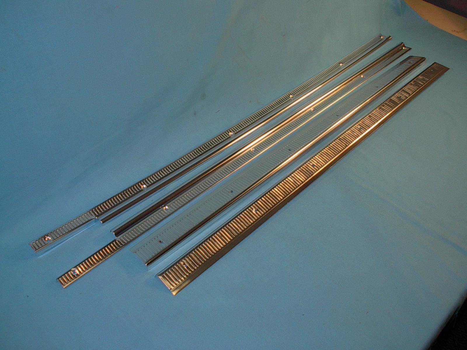 Door sill plates and interior carpet holddowns or also known as inner and outer polished aluminum plates.  (4 pieces in all in this kit)  Inner ones go up against the kickpanel back to the rear seat - border the edge of the carpet.  Outside ones are laying flat exposed when door is open - 2dr hardtop / Sedan models.