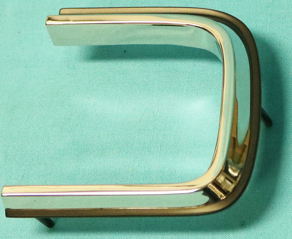 Taillight lens mldg- - Passenger side - painted black around edge. Not a pot-metal piece but a new reproduction two part alloy - won't pit.