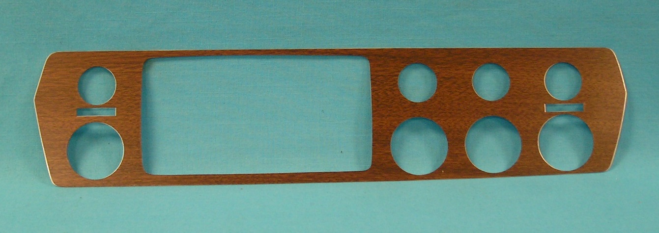 Dash woodgrain with light under temp gauge with seatbelt light.