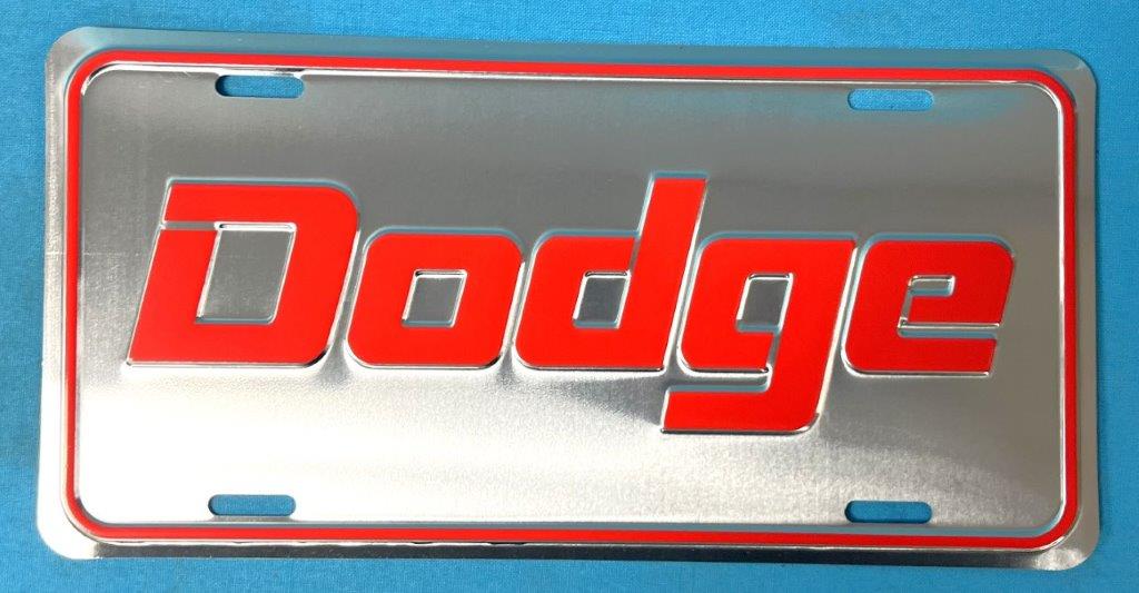 License Plate "Dodge" -Silver background with Dodge in red. Reproduction.