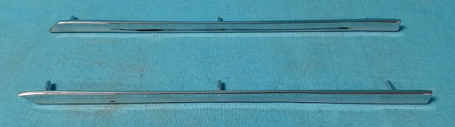 Rear Convertible Side chrome spears on rear interior panels.  These fit on the panel where the textured finish of the panel ends and the smooth section begins. (pair) 

These are NOT considered a High quality reproduction - they work and do the job but may have small imperfections (pin hole size one or two) on the part as the original used were the best we could find to tool from - ALSO they are just a hair shorter than originals depending on year and if you have Dart or Barracuda as we discovered after the fact that whatever set we got to tool from is a bit shorter (1/8" aprox) than some others we have seen - could be a year thing...or it could be from Dart versus Barracuda AND a year issue - since these were used in all three years 1967, 1968 and 1969....we have yet to figure out a science on which specific year or make has the longer versions by 1/8"...if that really is a concern even as nobody will likely tell when mounted on panels.