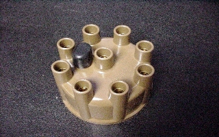 Distributor cap for all 1960-72 V8 models (including Hemi with Automatic transmission) with single-point distributors that were not equipped with a Prestolite distributor, and all 1972-89 V8 models with electronic distributors. This is a heavy-duty bakelite (not plastic) cap with brass contacts. This Original Chrysler part is <b>tan</b> color as original. Use with rotor part #TM-74401
Vented cap.