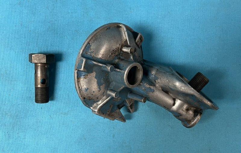 USED only -  Small-Block Oil Filter Adapter, Right angle filter adapter. This kit comes with the attaching bolt.  Purchase NEW seals to complete installation.